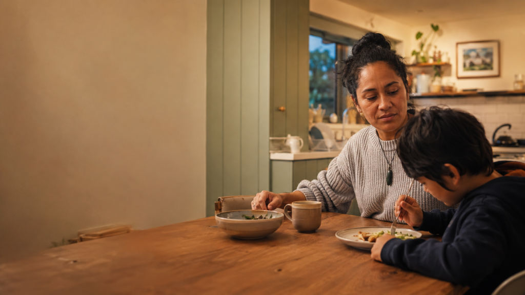 Mother and son at table eating